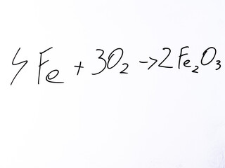 Minimal handwritten chemical equation &ldquo;4Fe + 3O₂ &rarr; 2Fe₂O₃&rdquo; on a white background. Reaction representing oxidation of iron and formation of rust.