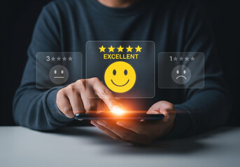 Businessman using smartphone for select smiley face icon for client evaluation and customer satisfaction after use product and service concept