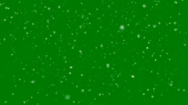 Snowflakes falling against green background for video projects