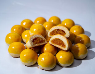 Nastar is a typical Indonesian pastry with a soft, buttery texture and a round shape. The exterior is baked until golden brown with a glossy egg wash, while the interior is filled with sweet, rich, an