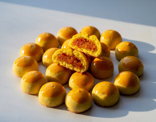 Nastar is a typical Indonesian pastry with a soft, buttery texture and a round shape. The exterior is baked until golden brown with a glossy egg wash, while the interior is filled with sweet, rich, an