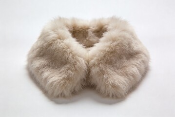 Faux fur collar with a realistic design placed on a plain background in neutral colors for display and inspection purposes
