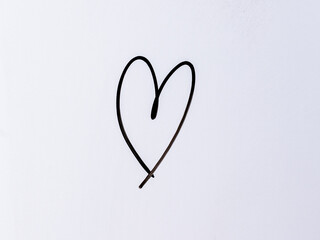 Minimal black heart symbol drawn on a white background. Concept representing love, affection, care and romantic feeling.