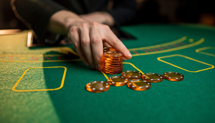Hand placing poker chips on casino table