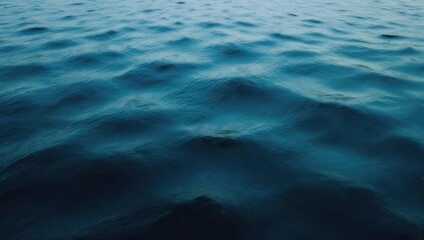 Fototapeta premium Close-up of the deep blue ocean water surface with gentle ripples and reflections under natural light.