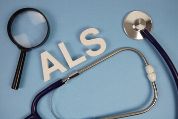 ALS Amyotrophic Lateral Sclerosis text with stethoscope on blue background