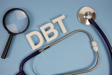 DBT Dialectical Behavior Therapy alphabet letters with Stethoscope and magnifying glass on blue background