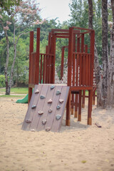Old wood climbing in playground on sand background