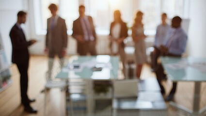 Business meeting in a modern office, blurred background showcasing a professional discussion among colleagues in a corporate setting