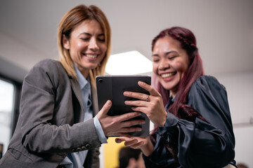 Two entrepreneurs collaborating on digital tablet for innovative solutions