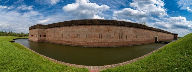 Fort Pulaski: Historic brick fort and moat under a dramatic sky.