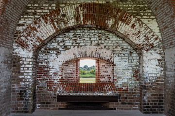 Fort Clinch: Historic brick archway frames lush outdoor view.