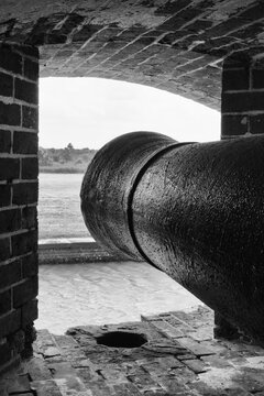 Fort Pulaski: Historic cannon points seaward from brick embrasure.