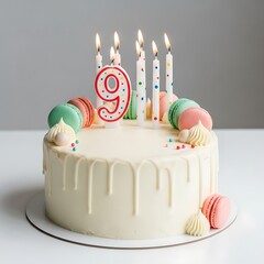 Elegant white drip cake celebrating nine years with colored macarons