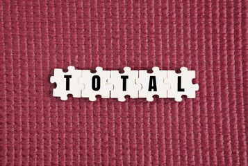 Wooden puzzle with the word total. whole or complete concept. comprising the whole number or amount.