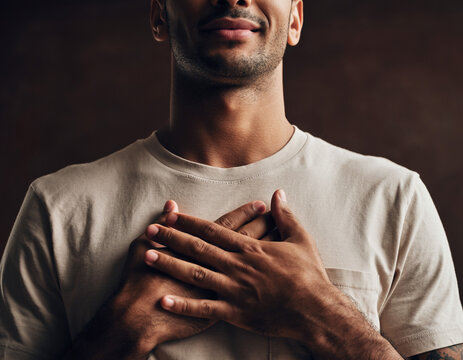 Visualizing Success. Health & Wellness Reset. An intimate portrait of a person with eyes closed, hands resting over their heart, a slight peaceful smile. Soft, diffused lighting..

