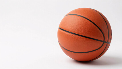 Fototapeta premium A classic orange basketball featuring distinct black channels and a pebbled leather texture sits isolated against a clean white background, highlighted by soft studio lighting.
