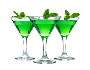 Three luminous green cocktails adorned with fresh mint sprigs