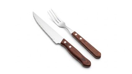 Naklejka premium Stainless steel steak knife and matching fork with warm wooden handles and rivets, arranged on a bright background, perfect for cutting and serving grilled meats in rustic yet refined table settings