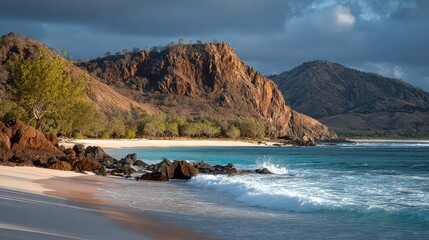 Tropical Sandy Beach with Turquoise Water and Rock Formations Under Dramatic Cloudy Sky in Warm Golden Light