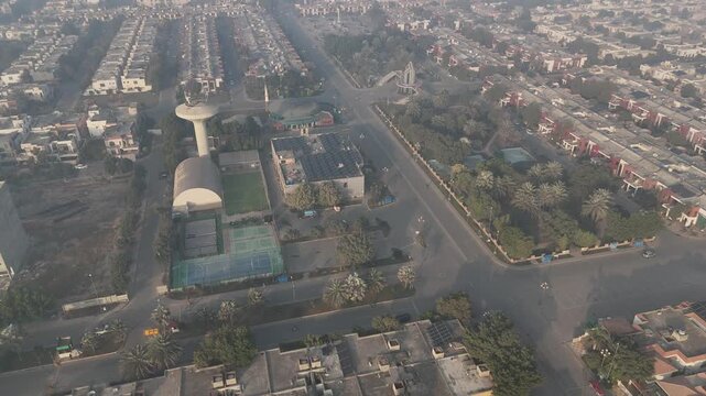 Aerial shot of Bahria Town Lahore at sunrise. Aerial Drone View Of Rows Of Modern Houses Bahria Town Drone view of Bahira town Lahore Pakistan Bahria Town Main Entrance Gate Aerial of the Bahria Town