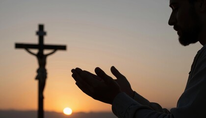 Silhouette of a Man Praying at Sunset with a Cross in the Background Evoking Calm and Reflection