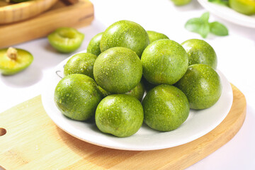 Fresh Green Apples with Water Droplets on White Plate