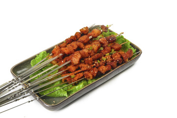 Spicy Grilled Meat Kebabs on Skewers with Lettuce Platter