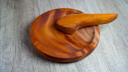 Wooden mortar and pestle on rustic wooden background