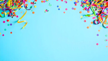 Vibrant party confetti and ribbons on bright blue background for celebration
