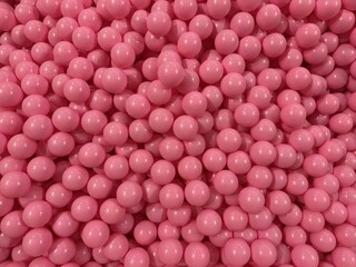 Pink plastic balls densely packed forming glossy round texture with playful abstract pattern and cheerful vibrant mood