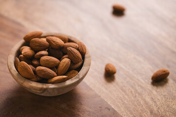 peeled almonds in wood bowl