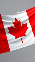Vibrant Canadian Flag Waving Proudly Against a Neutral Background.
