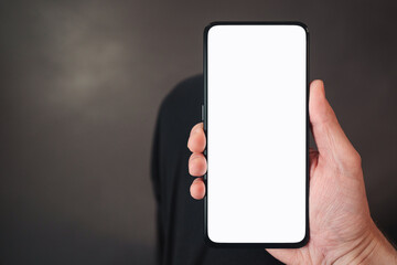 pov shot of man hand hold phone with white screen in dark interior
