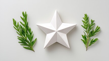 Obraz premium Minimalist White Star Decoration Surrounded by Fresh Green Leaves for Modern Home Aesthetic and Natural Elements in Interior Design