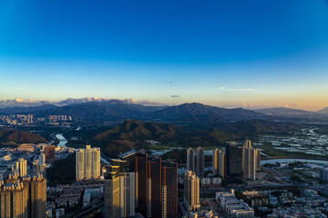 Shenzhen Luohu District Skyline at Sunset with Mountains © QuachVan