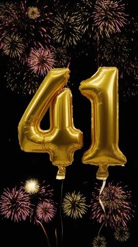 Gold balloon number 41 with fireworks in the background. Festive scene for birthday or anniversary party
