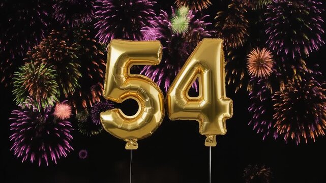 Gold balloon number 54 with fireworks in the background. Festive scene for birthday or anniversary party