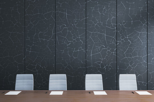 Modern empty conference room with wooden desk, paper sheets, and stylish chairs against dark cracked wall texture background interior design. 3D Rendering