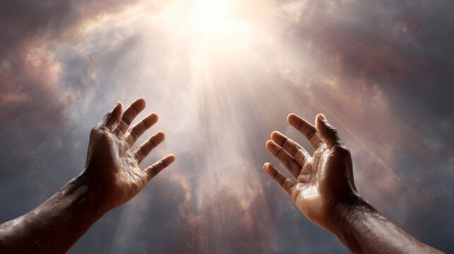 Two open hands reach upwards toward bright, heavenly sunlight breaking through dark, dramatic clouds. Hopeful