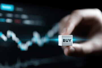 Hand presents glowing buy cube before dynamic financial chart suggesting bullish opportunity.