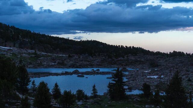Sunset pink sky over Beartooth Mountains lake timelapse 