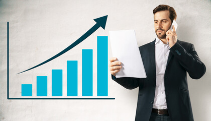 Businessman holding report and talking on smartphone with upward arrow chart symbolizing corporate growth on abstract light background.