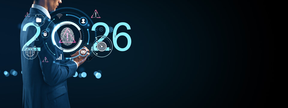 Businessman using futuristic technology interface with digital icons and glowing elements representing innovation and cybersecurity in 2026. - Powered by Adobe