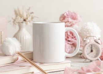 White ceramic coffee mug near pink decor and flowers, pastel spring valentines mockup, closeup