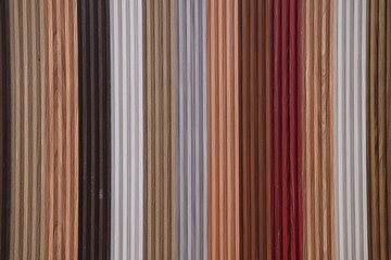 Colorful striped wooden background. Wood plank wall background texture. Seamless pattern of modern wall panels with vertical wooden slats for background