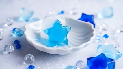 A white seashell with blue starfish and clear beads on white surface