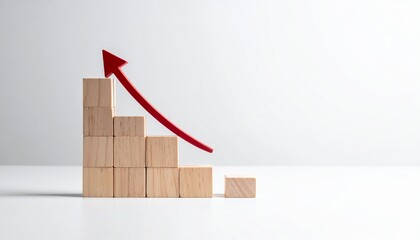 Wooden blocks arranged in descending staircase with upward red arrow, growth despite decline symbolism.