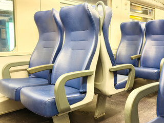Comfortable blue seats in empty modern train carriage