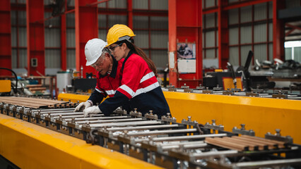 Industrial worker inspecting machines at the factory. Technician in metal sheet industry checking equipment and materials.